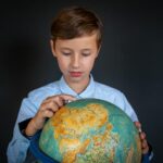 junior geographer working with maps